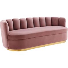 a pink velvet couch with gold legs