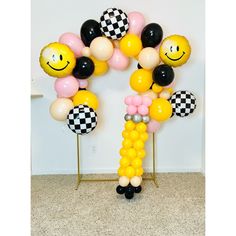 balloons are arranged in the shape of smiley faces and checkered balls, along with other decorations