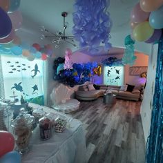 a room filled with balloons and decorations