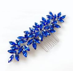 A stunning royal blue and silver bridal and occasion hair comb with beautiful faceted crystals.  Introducing our Enya Crystal Hair Comb - a sparkling accessory that brings elegance to your hair, perfect for any occasion. Our comb is adorned with shimmering crystals that catch the light, adding a touch of glamour to your look. It's versatile and complements various hairstyles, whether you wear your hair up or down.  It comes in a beautifully packaged, making it an ideal gift for friends, bridesma Royal Blue Hair, Occasion Hair, Hair Up Or Down, Beautiful Hair Accessories, Metal Headband, Crystal Hair Comb, Pearl Accessories, Metal Headbands, Blue Bridal