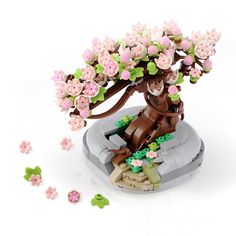 a lego tree with pink flowers and green leaves