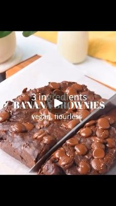 chocolate brownies on a white plate with a knife