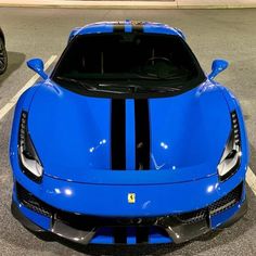 a blue sports car parked in a parking lot