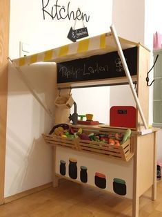 the kitchen is made out of wood and has a chalkboard on it's side