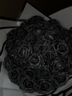 a black and white photo with roses on the bottom, in an artistic manner that looks like it has been made out of fabric