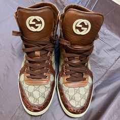 Very Good Condition! Gucci Brown Sneakers With Branded Heel Counter, Gucci Brown Sneakers With Branded Heel, Gucci Brown High-top Sneakers, Luxury Brown Leather High-top Sneakers, Designer Brown Gucci Sneakers, Brown Gucci Designer Sneakers, Designer Brown Calf Leather Sneakers, Designer Calf Leather High-top Sneakers, Gucci High Tops