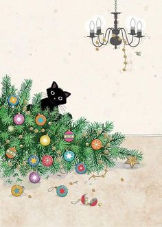 a black cat sitting on top of a christmas tree