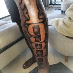 a man's leg with a tattoo on it