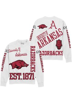 Make your way to the big game in this Arkansas RazorbacksWomens White Kelsey Crew Sweatshirt! This Razorbacks Long Sleeve Sweatshirt features a screen print team name and logos repeated all over garment. Stay warm and comfortable with this Womens Arkansas Razorbacks Crew Sweatshirt. Collegiate Tops For Game Day In Winter, Winter Fan Merchandise Tops With Team Logo, Winter Fan Merchandise Top With Team Logo, Throwback Fan Gear Tops For Fall, White Tops With Team Logo For Winter, White Winter Tops With Team Logo, Throwback Relaxed Fit Tops For Game Day, Relaxed Fit Throwback Tops For Game Day, Long Sleeve University Logo Tops For Sports Season