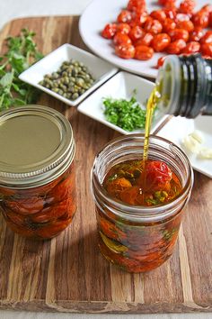 a jar filled with pickled vegetables and sauce being poured into it