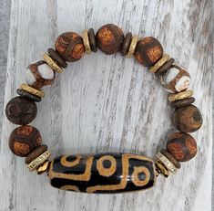 Materials used: Tibetan focal bead, Tibetan rough hewn beads, and brass spacers. Length: 7.75" African Beaded Bracelets, African Bracelet, Stackable Beaded Bracelets, Plate Jewelry, African Bracelets, Boho Beads, Braided Bracelet Diy, Earthy Jewelry, Brass Plate