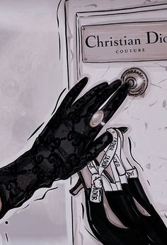 a woman's hand is holding on to a black lace glove that has the word christian dior written on it