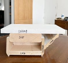 the table is made out of plywood and has two sections labeled with measurements for each piece