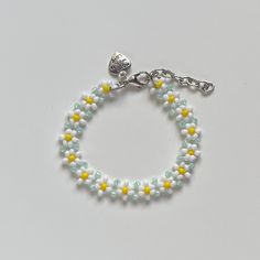 "Handmade Beaded Bracelet ✿ Made with glass seed beads and metal accents ✿ Milky white, yellow, and light seafoam green ✿ The bracelet has 1.5\" of extension chain" Handmade White Crystal Bracelet With Flower Shape, Handmade White Crystal Bracelet In Flower Shape, Handmade White Crystal Flower Bracelet, White Spring Jewelry For Friendship, Yellow Beaded Chain Bracelets, Yellow Beaded Chain Bracelet, White Spring Jewelry With Tiny Beads, Spring White Jewelry With Tiny Beads, Adjustable Yellow Beaded Bracelets With Beaded Chain