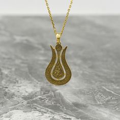 Crafted with intricate detail and spiritual significance, the Ayatul Kursi Tulip Necklace is more than just a piece of jewelry - it's a heartfelt token of faith and love. This exquisite necklace combines the elegance of 925 sterling silver with the luxurious touch of 18K Gold Plating, creating a stunning accessory that symbolizes strength and devotion. Adorned with Islamic calligraphy, including the revered Ayatul Kursi, this necklace is a meaningful gift for Muslim women, moms, or anyone looking to embrace their faith with style. Perfect for birthdays, anniversaries, or any special occasion, this necklace is a beautiful reminder of the power of faith and love. Give the gift of divine elegance with the Ayatul Kursi Tulip Necklace and let its beauty illuminate the heart of the recipient. Si Traditional Engraved Teardrop Necklace, Traditional Teardrop Pendant Jewelry Gift, Brass Necklaces With Intricate Design As Gift, Brass Necklaces With Intricate Design For Gifts, Intricate Brass Necklaces For Gift, Traditional Pendant Necklace For Blessing Ceremony, Traditional Teardrop Necklace For Gift, Spiritual Necklace With Flower Pendant And Intricate Design, Traditional Teardrop Pendant Necklace