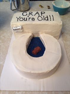 a cake that has been made to look like a toilet with the words crap you're old written on it