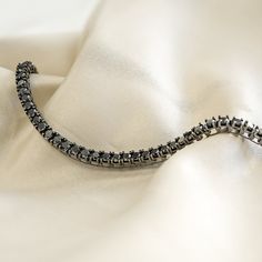 Timeless diamond link bracelet made with single black diamonds linked together to create this classy everyday piece. This 11 ct. black diamond link bracelet is a stunner on its own, but can be layered with other bracelets to create a nice arm stack. Length 8.50" - Black Diamonds - Available in Sterling Silver - Total Carat Weight: 11CT - Ethically sourced materials and conflict-free diamonds - Fully compliant with The Kimberley Process Elegant Gunmetal Jewelry For Formal Occasions, Formal Diamond Bracelet With Black Diamonds, Elegant Gunmetal Bracelet For Formal Occasions, Luxury Bracelets With Black Diamonds As Gifts, Black Diamond Bracelet Jewelry, Luxury Black Diamond Bracelets As Gift, Black Diamond Bracelets, Minimalist Black Diamond Jewelry For Formal Occasions, Formal Bracelets With Black Diamonds