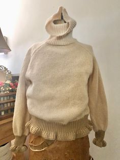 This is my favorite sweater find of this season! 1970s handmade wool ruffle sweater. The body is oatmeal in color with contrasting ruffles at the body and cuff edges. Chunky knit with turtleneck collar. Cozy and warm- perfect for the coming colder weather. This piece has stretch and give. Fits xs-l. Fantastic condition. No tag. Washed and ready to wear.  MEASUREMENTS(taken flat, double when appropriate) PTP 20, Waist 16, Length 21 This is the perfect gift for a loved one, or yourself! Vintage is at least 20 years old, and typically preloved with its own unique history. Every piece tells a story. Each item is sold as is and as described in the listing. The photographs are used to give an idea of what the garment would look like on the body, but please refer the measurements. If you need mor Ruffle Sweater, Pullover Outfit, Womens Sweaters, Favorite Sweater, Love And Light, Chunky Knit, Turtleneck Sweater, Sweater Outfits, Hand Knitting