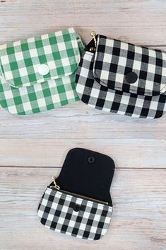 two black and white checkered purses sitting on top of a wooden floor next to each other