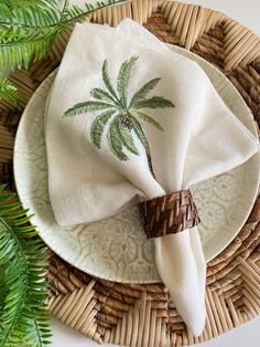 a palm tree napkin on top of a wicker plate