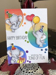 a birthday card with two elephants holding balloons