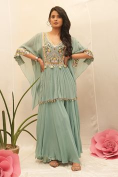 Topaz green kurta with thread embroidered floral jaal patterns, embellished by mirrorwork and pearl shell tassels. Comes with sharara. - Aza Fashions Shell Tassels, Sharara For Women, Embroidered Kaftan, Cape Sleeves, Pearl Shell, Petunias, Aza Fashion, Topaz, Tassels