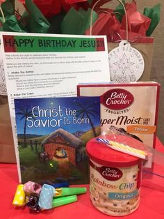 a table topped with ice cream and candy next to a sign that says christ the savor is born