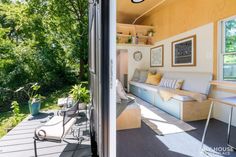 the inside of a tiny house with patio furniture