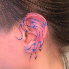 a person with blue ink on their ear