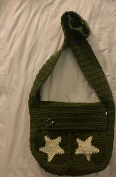 a green crocheted purse with white stars on it