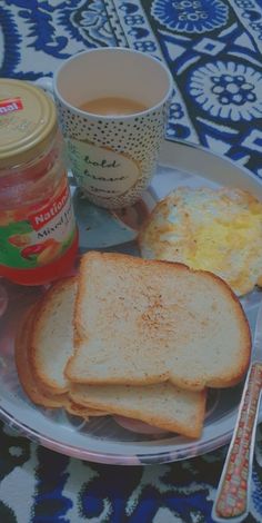 a plate with toast, eggs and jam on it