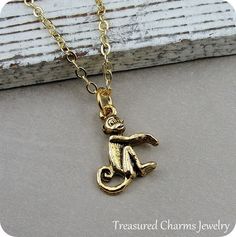 This Tiny Monkey Charm necklace comes on a gold plated chain that is available in different lengths. Please choose your desired length from the drop-down menu when placing the item in your shopping cart. { CHARM DETAILS }★ Material: Pewter ★ Finish Color: Gold★ Measurements: 1/2" x 5/8"★ Dimensions: Two-sided★ Made in the USA{ KEEP SHOPPING } More monkey themed items available from my shop: https://www.etsy.com/shop/treasuredcharms/search?search_query=monkey{ PACKAGING }Packaging varies but item Monkey Necklace, Gold Monkey, Monkey Accessories, Monkey Jewelry, Tiny Monkey, Pandora Beads, Necklace Ideas, Small Jewelry Box, Jungle Safari