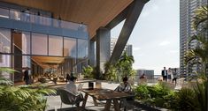 two people sitting at a table in front of an office building with tall buildings and palm trees