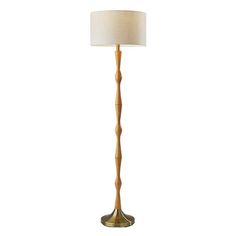 a wooden floor lamp with a white shade