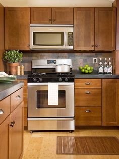 a kitchen with wooden cabinets and stainless steel appliances