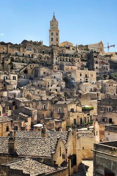 an old city with lots of buildings and a clock tower on the top of it