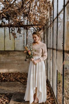 a woman in a white dress holding a bouquet