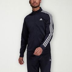 This adidas men's midweight track jacket is a lounging and workout essential. Crafted from tricot, this classic-fit jacket features the brand's signature striped design and has a mock neck, zip closure, and side pockets. Style with jogger pants or workout shorts. Closure Type: ZipperFit: Classic FitNeckline: Mock NeckPockets: 2 Side Slip PocketsSleeve Length: Long SleeveWarmth Factor: MidweightOuterwear Length: MidFiber Content: 100% PolyesterFabric Description: TricotCoat Style: Track JacketsCa Adidas Moisture-wicking Track Jacket, Adidas Moisture-wicking Sportswear Track Jacket, Adidas Sporty Track Jacket For Training, Adidas Sporty Tracksuit For Sports, Adidas Training Track Jacket, Adidas Athleisure Track Jacket With Side Stripes, Functional Track Jacket With Three Stripes For Sports Season, Athleisure Track Jacket With Three Stripes For Training, Athleisure Outerwear For Sports Events With Three Stripes