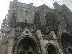 an old church with rain drops on the window