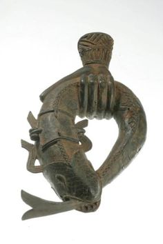 an old bronze figurine with a lizard on it's back