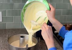 a woman pouring batter into a pot on the stove