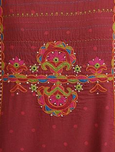 an embroidered red cloth with colorful designs on it