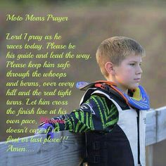 a young boy leaning on a fence with his back to the camera