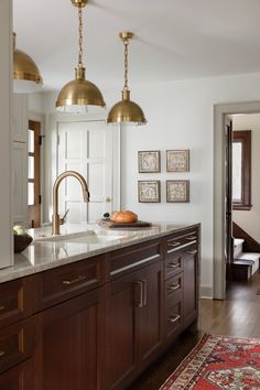 a kitchen with wooden cabinets and brass fixtures