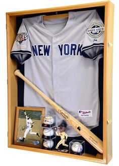 a baseball uniform and bat in a wooden case