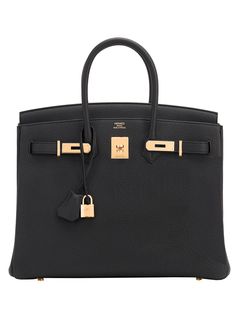 HERMES BIRKIN 35 BLACK TOGO LEATHER HERMES BIRKIN 35 BLACK TOGO LEATHER WOMEN'S LUXURY HANDBAG - With Manufacturer Serial Numbers - 2018 Version - Made in France - Black Togo Leather - Rolled Leather Top Handles - Front Toggle Closure in Gold - Black Chevre Goatskin Leather Interior - One Interior Zipper Pocket with Hermes Engraved Zipper - One Interior Open Pocket - Gold Hardware     Gold Feet Protect Bottom of Bag - Two Keys and One Lock     Keys Enclosed in Leather Lanyard Known as a Clochette - Measurements:     Length: 13.50 in.     Width: 7.50 in.     Height: 11 in.     Drop: 4 in. - Accompanied by: Hermes Box, Hermes Dustbag, Clochette, Lock, Two Keys, Clochette Dustbag, Rainhat, and Felt.     Also Known As Model # Hermes Birkin Bag 35cm / Togo Birkin Bag / Hermes Purse Hermes Black Black Birkin Bag, Hermes Birkin 35 Black, Hermes Birkin Bag 35cm, Birkin 25 Black, Birken Bag, Black Birkin, Birkin 35 Black, Hermes Purse, Hermes Birkin Bag