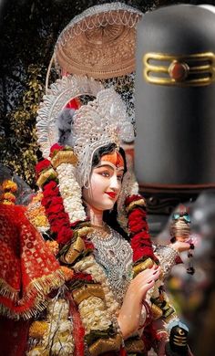 a woman dressed in costume holding a bell