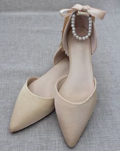 "Satin pointy toe flats with beautiful row of pearls as ankle strap. Comfortable throughout your special day and perfect for holiday party, night out and wedding party. YOU CAN CHOOSE THE PEARLS ANKLE STRAP AT CHECKOUT Details: COLORS AVAILABLE: Black, Blush, Burgundy, Champagne, Light Blue, Navy, Red, Royal Blue, Ivory, and White UPPER: Synthetic upper and lining MATERIALS: Mandmade outsole STYLE NAME: BELLA SIZE FIT: RUNS LARGE, ORDER HALF SIZE DOWN FROM YOUR NORMAL SIZE Not sure of which size Elegant Bridesmaid Pointed Toe Flats, Elegant Cream Flats For Party, Elegant Pointed Toe Flats For Bridesmaids, Elegant Pointed Toe Flats With Ankle Strap For Wedding, Elegant Wedding Pointed Toe Flats With Ankle Strap, Elegant Closed Toe Bridesmaid Flats, Elegant Bridesmaid Closed Toe Flats, Elegant Cream Pointed Toe Flats, Elegant Pointed Toe Bridesmaid Flats