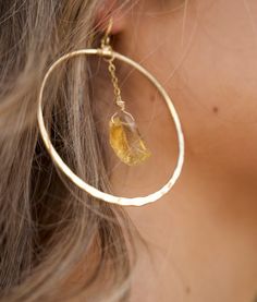 "Raw citrine gold hoops to raise your positive energy and good vibes! Super lightweight and comfortable to wear all day, these are going to be your new favorites. The yellow citrine crystal clusters float inside the hoop like magic, hitting the light from every angle. You can't help but feel like life is happy, fun, and easy-breezy when you're wearing your new citrine hoops! ▲ Raw Citrine Gemstone ▲ 2\" Gold plated hoops ▲ Weight: 1/4 oz ▲ Hypoallergenic ▲ Comes gift-ready in a beautiful white j Crystal Clusters, Raw Citrine, Boho Handmade, Earrings Gemstone, Crystal Dangle Earrings, Hammered Gold, Yellow Citrine, Citrine Crystal, November Birthstone