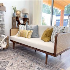 a living room filled with furniture and a fire place in front of a large window